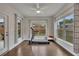 Bright sunroom with a treadmill, large windows, and hardwood floors, perfect for exercise or relaxation at 463 Marston Pass, Acworth, GA 30102