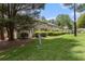 Exterior view of the townhome's back, featuring a grassy area and patio with wooden fence at 6900 Roswell Rd # F6, Atlanta, GA 30328