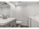 Cozy bathroom featuring a sink, toilet, and washing machine, offering practicality and convenience at 6900 Roswell Rd # F6, Atlanta, GA 30328