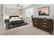 Bedroom staged with modern furnishings, carpet, and natural light through a window at 6900 Roswell Rd # F6, Atlanta, GA 30328