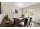 Classic dining room features a table set for four, elegant art, and bright natural light at 6900 Roswell Rd # F6, Atlanta, GA 30328