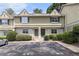 Townhome facade with stone accents, well-maintained landscaping, and parking at 6900 Roswell Rd # F6, Atlanta, GA 30328