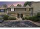 Townhome facade during sunset with stone accents, landscaping, and parking at 6900 Roswell Rd # F6, Atlanta, GA 30328