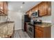 The updated kitchen is equipped with granite countertops, stainless appliances, and modern fixtures at 6900 Roswell Rd # F6, Atlanta, GA 30328