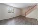 Inviting living room with modern wood-look floors, a staircase, and plenty of natural light at 6900 Roswell Rd # F6, Atlanta, GA 30328