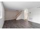 Spacious living room with hardwood floors and staircase offers a bright and airy feel at 6900 Roswell Rd # F6, Atlanta, GA 30328
