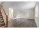 Bright living room featuring wood-look flooring, a staircase, and freshly painted white walls at 6900 Roswell Rd # F6, Atlanta, GA 30328