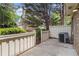 Enclosed patio offers a private outdoor space with fence, greenery and an air conditioning unit at 6900 Roswell Rd # F6, Atlanta, GA 30328