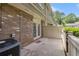 Cozy back patio with brick accents, a wooden fence, and an air conditioning unit at 6900 Roswell Rd # F6, Atlanta, GA 30328