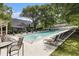 Community pool surrounded by mature trees and various seating options at 6900 Roswell Rd # F6, Atlanta, GA 30328
