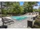 Community pool featuring lounge chairs and well maintained grounds at 6900 Roswell Rd # F6, Atlanta, GA 30328