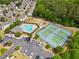 Aerial view of community amenities including a pool, tennis courts, playground, parking, and surrounding greenery at 138 Fox Creek Dr, Woodstock, GA 30188