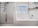 Bright bathroom with a soaking tub, glass-enclosed shower, and bright white tile at 138 Fox Creek Dr, Woodstock, GA 30188
