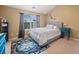 Bright bedroom featuring a large window, a plush bed, and colorful accents at 138 Fox Creek Dr, Woodstock, GA 30188