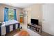 Inviting bedroom with a striped bed, a TV stand, and a bright window at 138 Fox Creek Dr, Woodstock, GA 30188