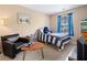 Comfortable bedroom with a striped bed, blue curtains, and a cozy reading area at 138 Fox Creek Dr, Woodstock, GA 30188