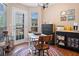 Dining area features a colorful round rug, seating for three, and natural light from the patio door and window at 138 Fox Creek Dr, Woodstock, GA 30188