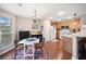 Kitchen and dining area with bright natural light, stainless steel appliances, and wood cabinets at 138 Fox Creek Dr, Woodstock, GA 30188