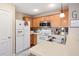 Kitchen features white appliances, wooden cabinets, and a stainless steel microwave and sink area at 138 Fox Creek Dr, Woodstock, GA 30188