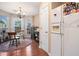 Bright kitchen and dining area features white appliances, an adjacent pantry, and a door to the patio at 138 Fox Creek Dr, Woodstock, GA 30188
