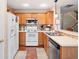 Kitchen featuring wood cabinets, stainless steel appliances and a breakfast bar with seating for two at 138 Fox Creek Dr, Woodstock, GA 30188