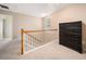 Upstairs landing features neutral carpeting and a black dresser at 138 Fox Creek Dr, Woodstock, GA 30188