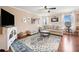 Inviting living room with hardwood floors, ceiling fan, and natural light at 138 Fox Creek Dr, Woodstock, GA 30188