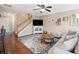 Open concept living room with hardwood floors, ceiling fan, and staircase at 138 Fox Creek Dr, Woodstock, GA 30188