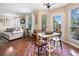 Open-concept living room with hardwood floors, casual seating, and a brightly lit dining space adjacent to a patio door at 138 Fox Creek Dr, Woodstock, GA 30188