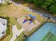 Community playground with slides and climbing structures adjacent to tennis courts and a walking trail at 138 Fox Creek Dr, Woodstock, GA 30188