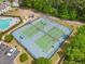 Aerial view of community tennis courts next to a playground and wooded area, providing ample recreational opportunities at 138 Fox Creek Dr, Woodstock, GA 30188