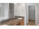 This bathroom features a double sink vanity with granite top, shower, and walk-in closet access at 481 Jefferson Chase Se Cir, Atlanta, GA 30354