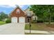 Beautifully landscaped two-story home with a brick front and a two-car garage at 481 Jefferson Chase Se Cir, Atlanta, GA 30354