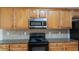 Kitchen features stainless steel appliances, wood cabinets, and granite countertops at 481 Jefferson Chase Se Cir, Atlanta, GA 30354