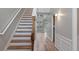 This is a staircase leading to the second floor, natural lighting, and hardwood flooring at 481 Jefferson Chase Se Cir, Atlanta, GA 30354