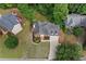 Overhead view of a brick house with dark roof, surrounded by green trees and manicured lawn in a neighborhood setting at 5344 Saint Martins Se Ct, Mableton, GA 30126