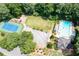 Aerial view of community amenities featuring a pool, tennis court, playground, parking, and green space at 5344 Saint Martins Se Ct, Mableton, GA 30126