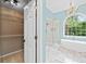 Transitional bathroom featuring a soaking tub, shower, chandelier and direct access to the closet at 5344 Saint Martins Se Ct, Mableton, GA 30126