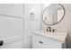 Elegant bathroom with a white vanity, granite countertop, round mirror, and shaker-style cabinets at 5344 Saint Martins Se Ct, Mableton, GA 30126