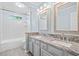 Bathroom with double sinks, gray vanity, granite countertop, tiled floor, and shower-tub combo at 5344 Saint Martins Se Ct, Mableton, GA 30126