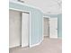 Bedroom featuring dual windows, light blue walls, and a walk-in closet at 5344 Saint Martins Se Ct, Mableton, GA 30126