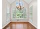 Cozy dining room with vaulted ceiling, hardwood floors, large windows and decorative chandelier at 5344 Saint Martins Se Ct, Mableton, GA 30126