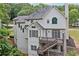 Exterior view showcases the back of the house with large deck and well-maintained yard at 5344 Saint Martins Se Ct, Mableton, GA 30126