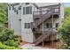 Multi-level back deck with stairs leading to a stone paver patio and landscaped yard at 5344 Saint Martins Se Ct, Mableton, GA 30126