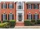 Close up of brick home's front entrance with a glass door and neatly trimmed bushes at 5344 Saint Martins Se Ct, Mableton, GA 30126