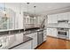 Elegant kitchen with white cabinets, granite countertops, stainless steel appliances, and hardwood floors at 5344 Saint Martins Se Ct, Mableton, GA 30126