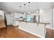 Bright kitchen featuring white cabinets, stainless steel appliances, and a spacious breakfast bar at 5344 Saint Martins Se Ct, Mableton, GA 30126