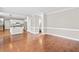 Open-concept living room with hardwood floors, access to the kitchen, and neutral wall colors at 5344 Saint Martins Se Ct, Mableton, GA 30126