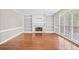 Bright living room with a fireplace, built-in shelves, hardwood floors, and large windows at 5344 Saint Martins Se Ct, Mableton, GA 30126