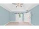 Spacious main bedroom featuring tray ceilings, ceiling fan, and barn-style bathroom door at 5344 Saint Martins Se Ct, Mableton, GA 30126
